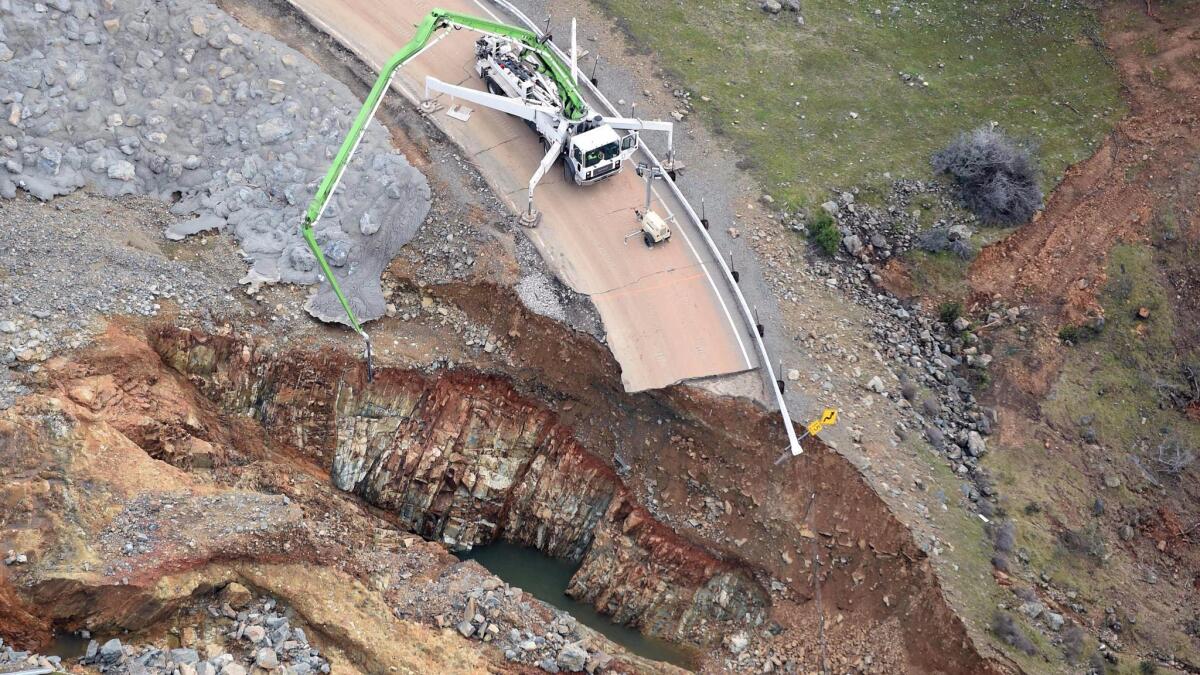 Concrete is injected around boulders added to armor the eroded hillside next to Lake Oroville. The hillside was armored amid fears it would erode and cause a collapse of a concrete retaining wall that holds a 30-foot wall of water when Lake Oroville is filled to the brim.