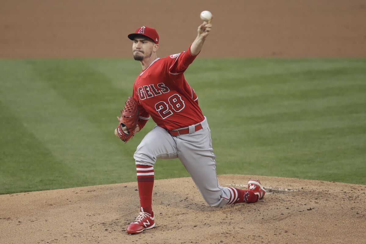 Los Angeles Angels pitcher Andrew Heaney works against the Oakland Athletics.