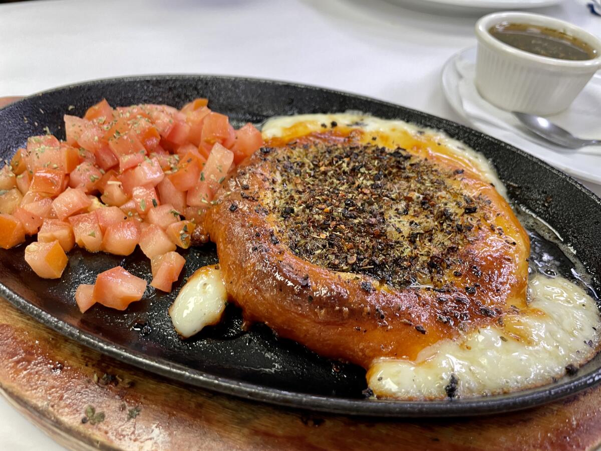 Provoleta cheese served on a hot skillet at Mercado Buenos Aires in Van Nuys.