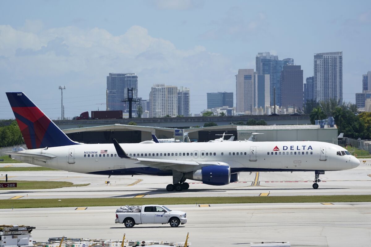 A Delta Air Lines Boeing 757 taxis on the runway, Thursday, July 7, 2022, at the Fort Lauderdale-Hollywood International Airport in Fort Lauderdale, Fla. Delta Air Lines said Wednesday, July 13, 2022, that it earned $735 million in the second quarter. Earnings per share fell short of Wall Street expectations, however, which the airline blamed on high fuel prices and more than 4,000 canceled flights in May and June. (AP Photo/Wilfredo Lee)