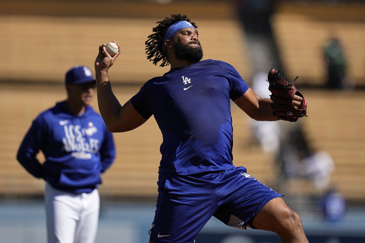 Dodgers manager Dave Roberts watches Kenley Jansen warm up before Game 3 of NLCS against the Atlanta Braves in October.