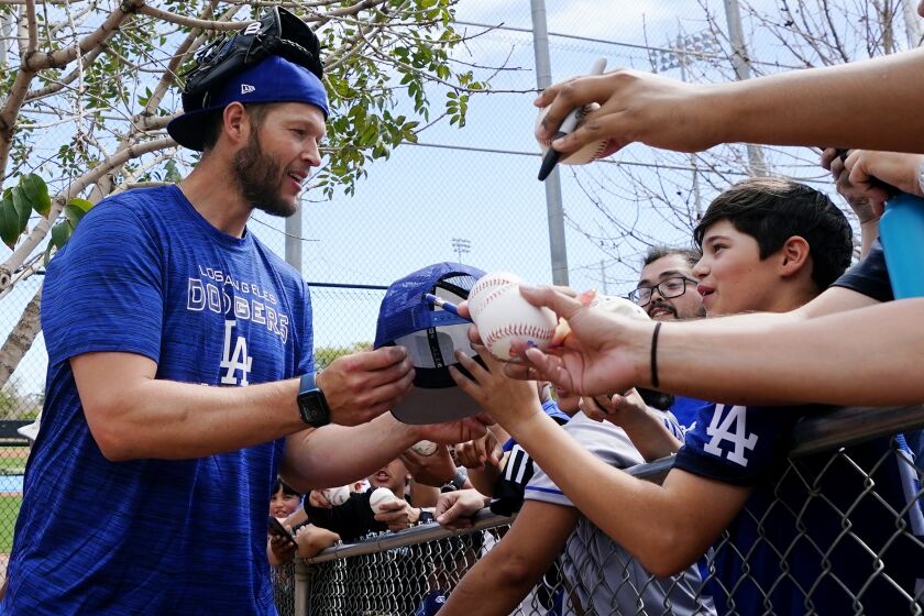 Dodgers pitcher Clayton Kershaw signs autographs after a spring training workout March 13 in Phoenix.
