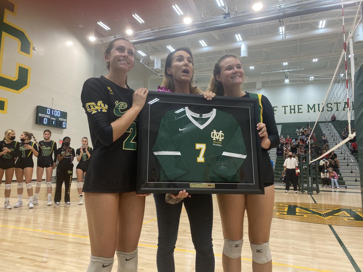 Former Mira Costa, UCLA and beach volleyball standout Holly McPeak receives a framed high school jersey.
