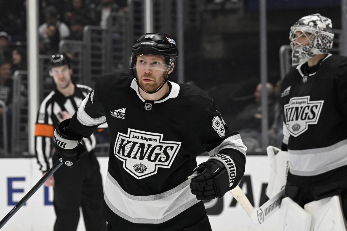 Kings defenseman Vladislav Gavrikov skates next to goaltender Darcy Kuemper