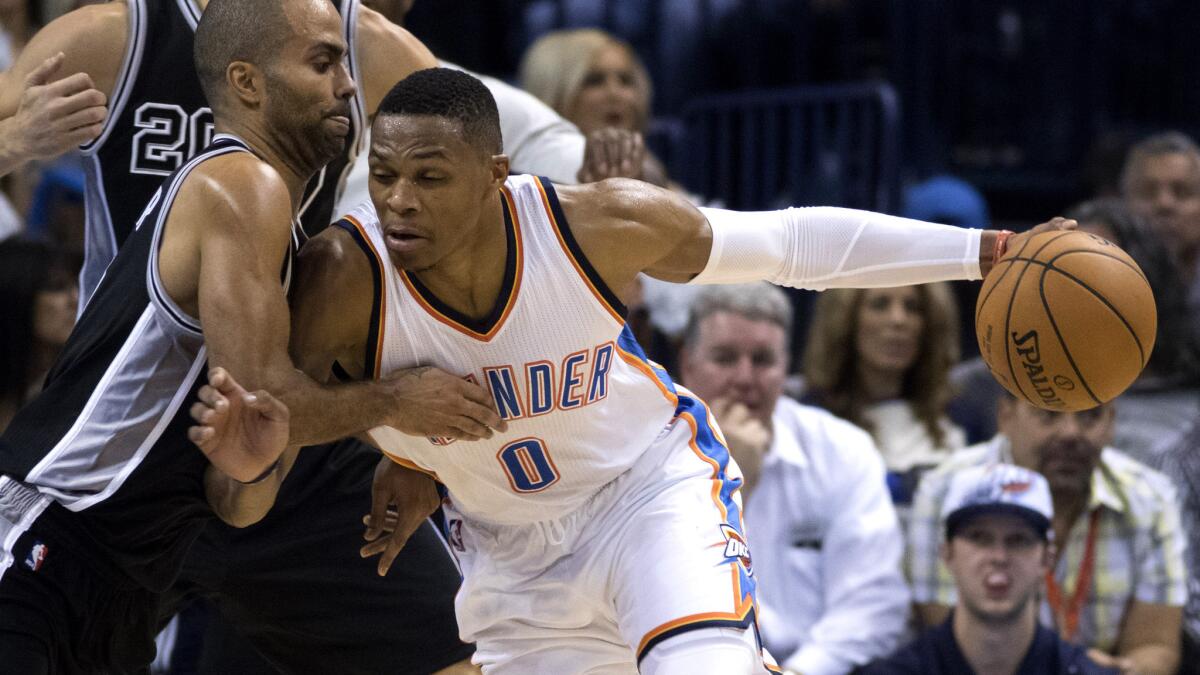 Thunder point guard Russell Westbrook tries to drive past Spurs point guard Tony Parker in the second half Wednesday night.