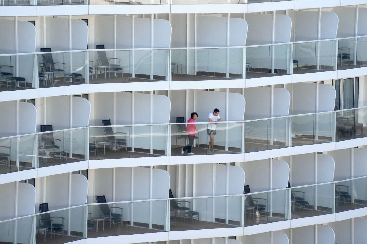 Passengers looking out from their room aboard cruise ship
