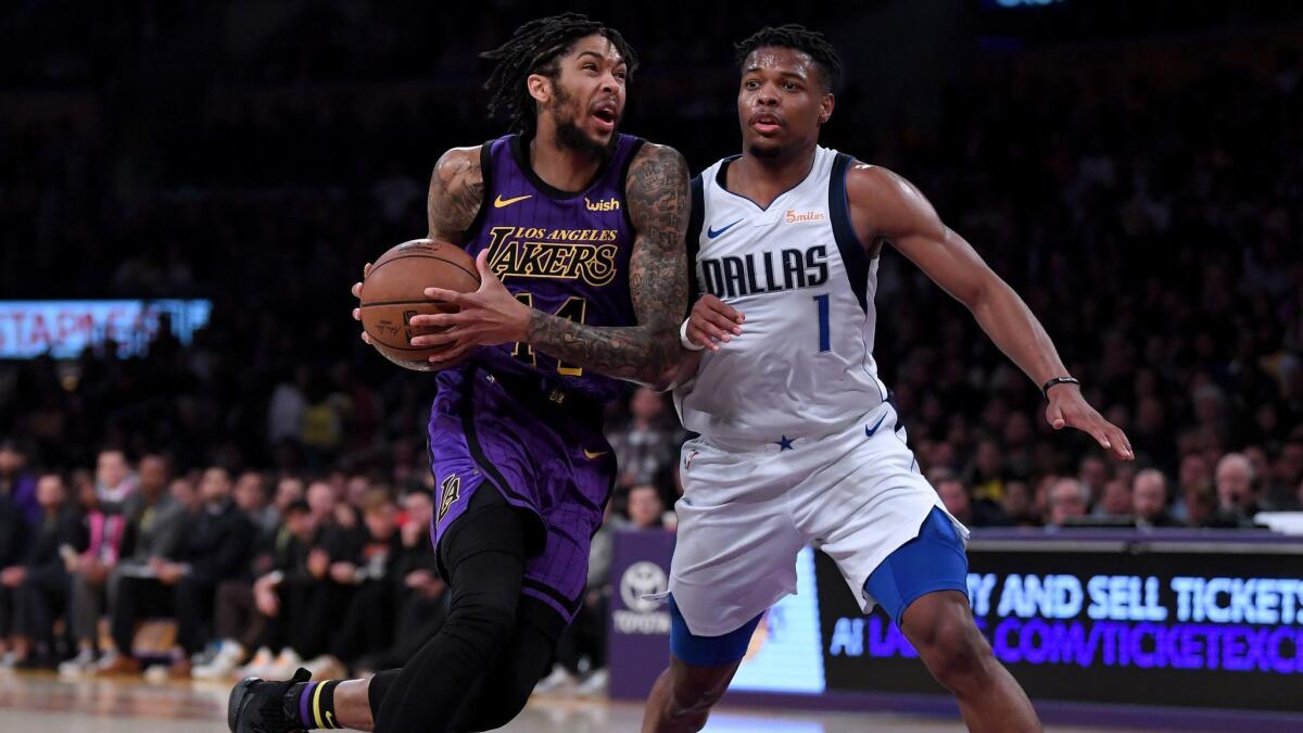 Brandon Ingram of the Lakers drives to the basket on Dennis Smith Jr. (1) of the Dallas Mavericks during a 114-103 Laker win at Staples Center on November 30, 2018.