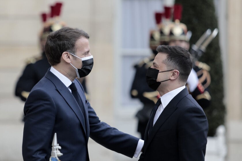French President Emmanuel Macron, left, welcomes Ukrainian President Volodymyr Zelenskyy at the Elysee palace in Paris, Friday, April 16, 2021. Ukrainian President Volodymyr Zelenskyy is holding talks with French President Emmanuel Macron and German Chancellor Angela Merkel amid growing tensions with Russia, which has deployed troops at the border with the country. (AP Photo/Lewis Joly)