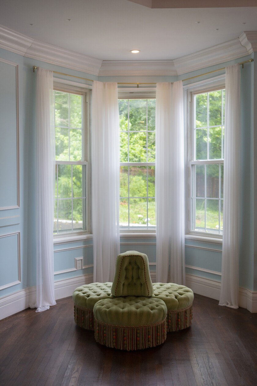 Tthe Artys chose a bright blue paint color for the walls of this living area, and white wainscoting provides visual detail.