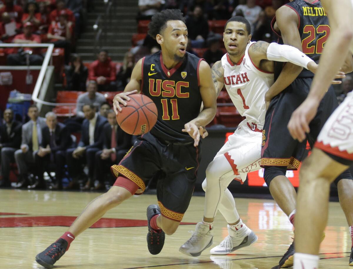 USC guard Jordan McLaughlin (11) drives around Utah guard JoJo Zamora (1) in the first half on Jan. 12.