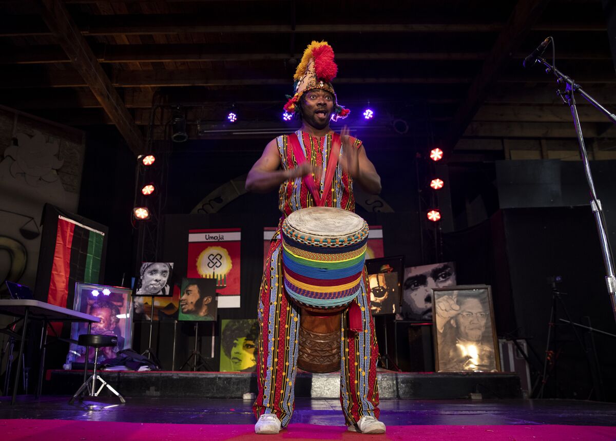 Dramane Kone of Burkina Faso in West Africa does a drum call for the first day of Kwanzaa at the WorldBeat Cultural Center.
