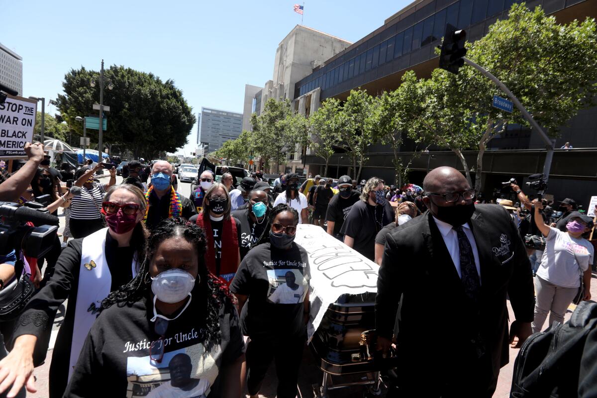 A coffin is carried in honor of George Floyd at a Black Lives Matter-L.A. memorial service and funeral procession Monday.