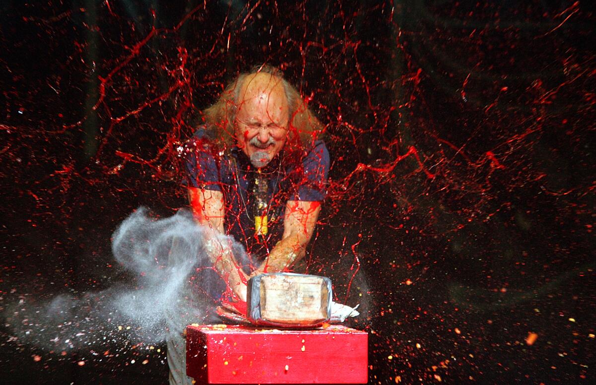 A man on stage with juice splashing 