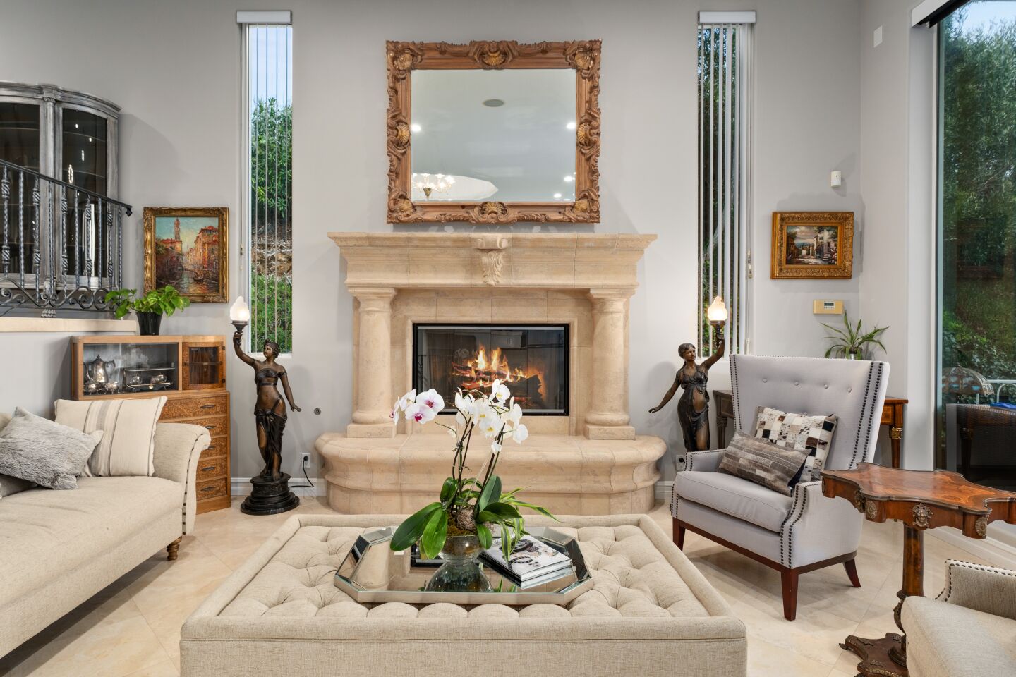An ornate fireplace anchors the far wall in the living room.