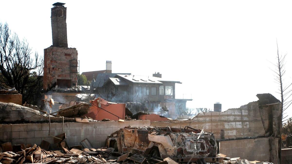 Coverage of California's wildfires competed for airtime with elections and politics on cable news networks. Above, a home in Malibu leveled by the Woolsey fire.