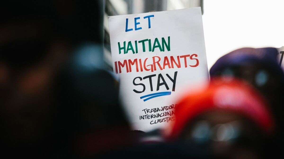 A protester holds a sign at a rally in New York on Jan 15.