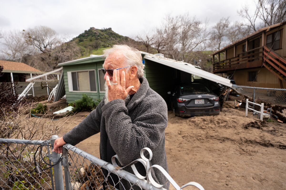 Bill Woodmansee cries as he describes the damage done to his home and the rentals he owns.  Woodmansee had no flood insurance. 