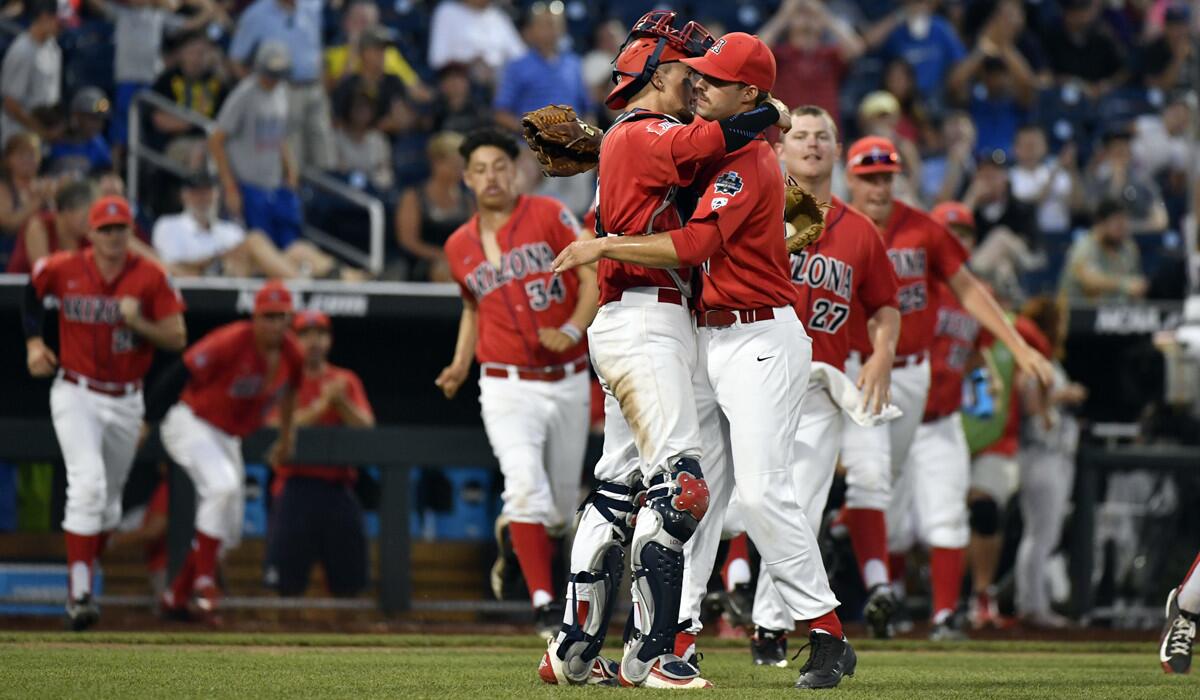 Arizona catcher Ryan Haug, front left, and relief pitcher Cameron Ming celebrate as teammates run out of the dugout following a College World Series baseball game against UC Santa Barbara on Wednesday.