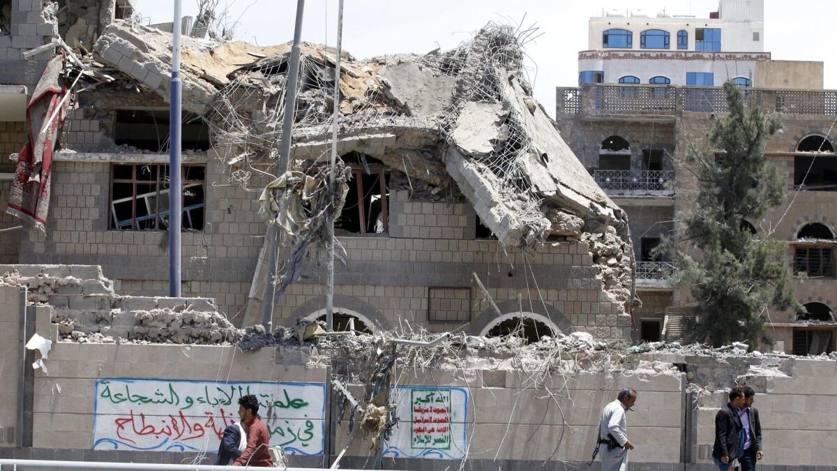Yemenis inspect the site of an airstrike that hit the presidency building in Sana, Yemen, on May 7.