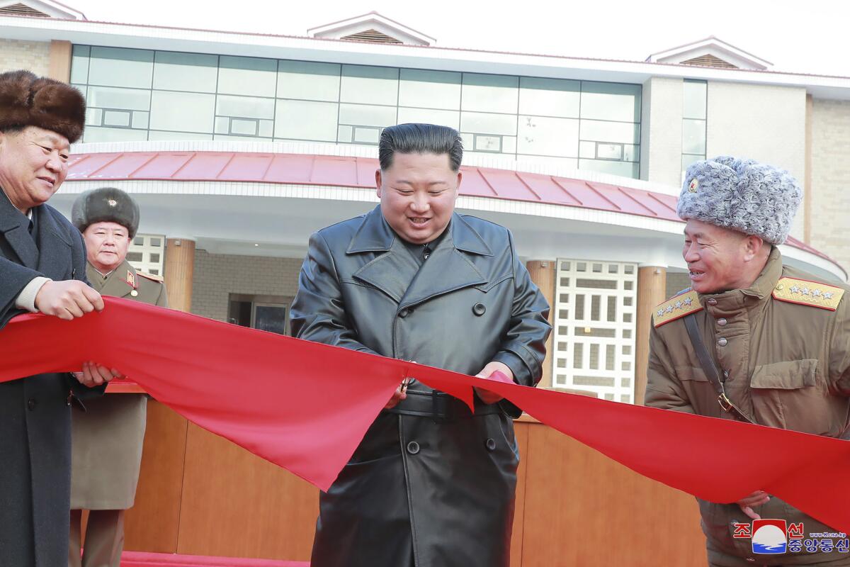 North Korean leader Kim Jong Un cuts the ribbon during a ceremonial opening of the Yangdok Hot Spring Cultural Recreation Center.