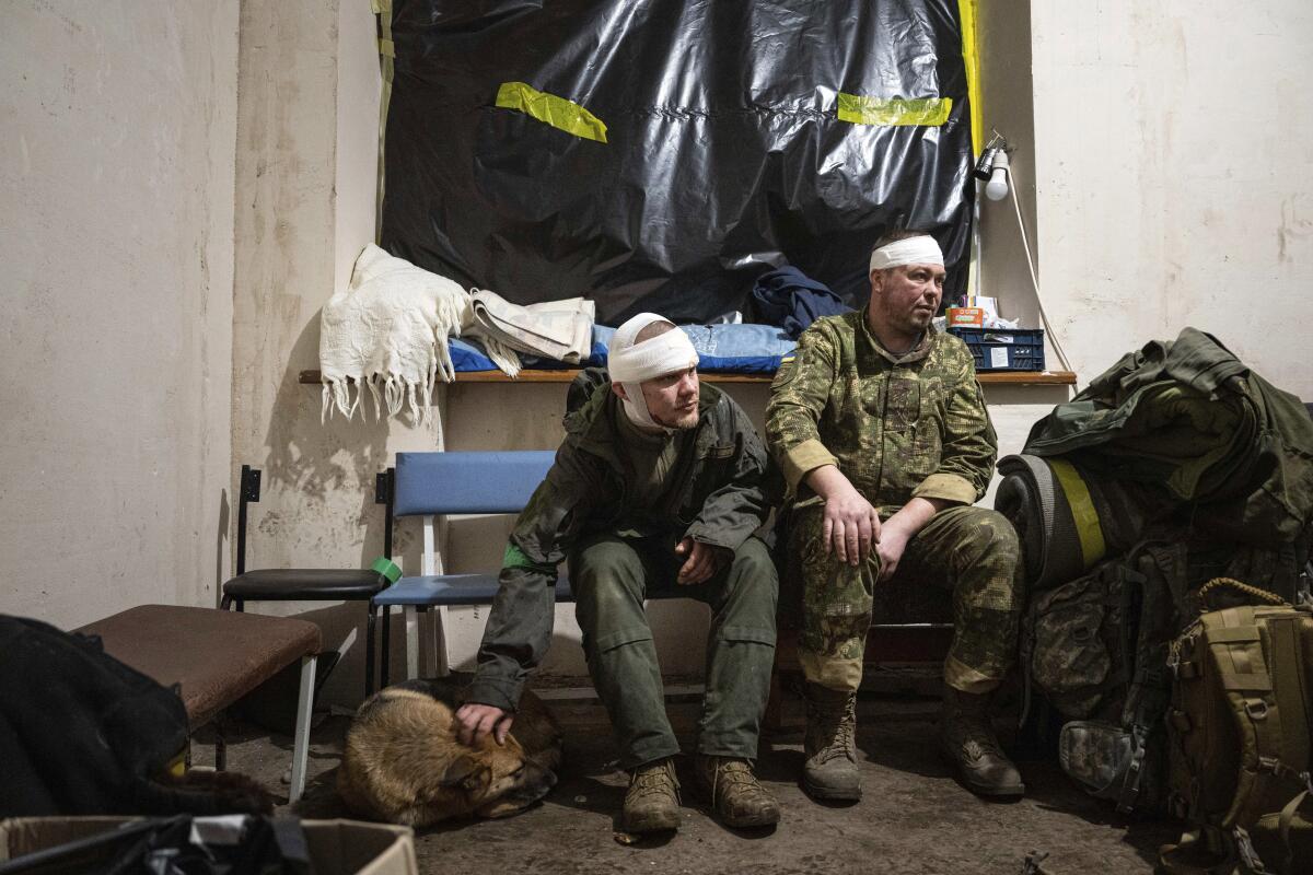 Wounded Ukrainian servicemen sit in a field hospital