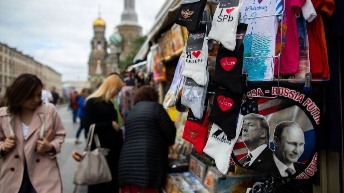 Shirts with pictures of President Trump and Russian President Vladimir Putin are displayed at an open market in St. Petersburg, Russia,