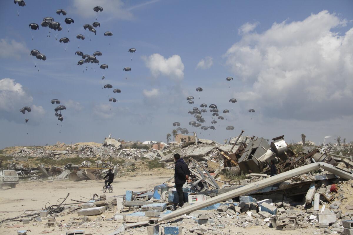 Humanitarian aid is airdropped to Palestinians over Gaza City.