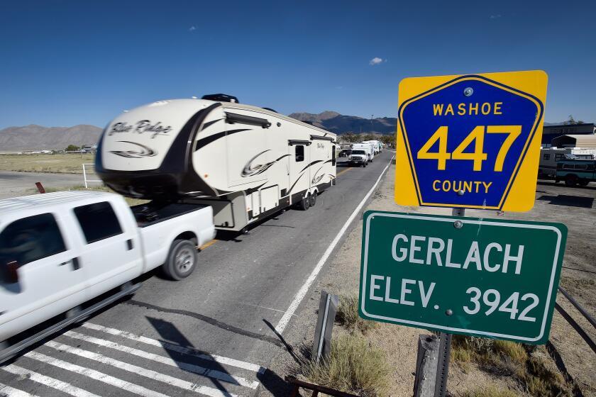 Trucks with trailers travel along county highway 447 through Gerlach, Nev. in route to the Black Rock Desert Tuesday, Aug. 23, 2016. Seventy thousand people are expected to travel though the small and quiet northern Nevada town in route to the annual counterculture Burning Man festival. (David Becker/ For the Times)
