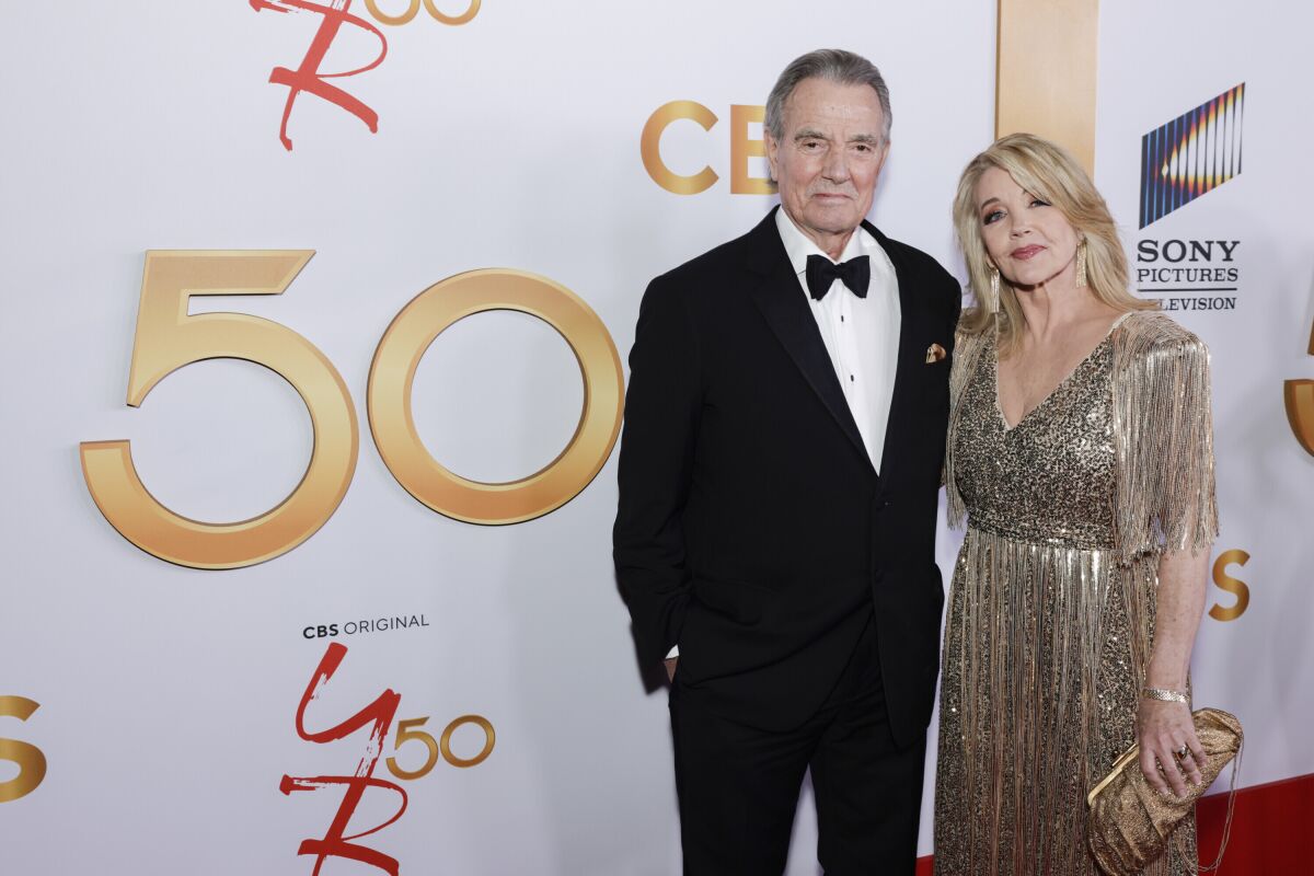This image released by CBS shows Eric Braeden and Melody Thomas Scott the 50th Anniversary celebration for the daytime series "The Young and The Restless" in Los Angeles. (Francis Specker/CBS via AP)