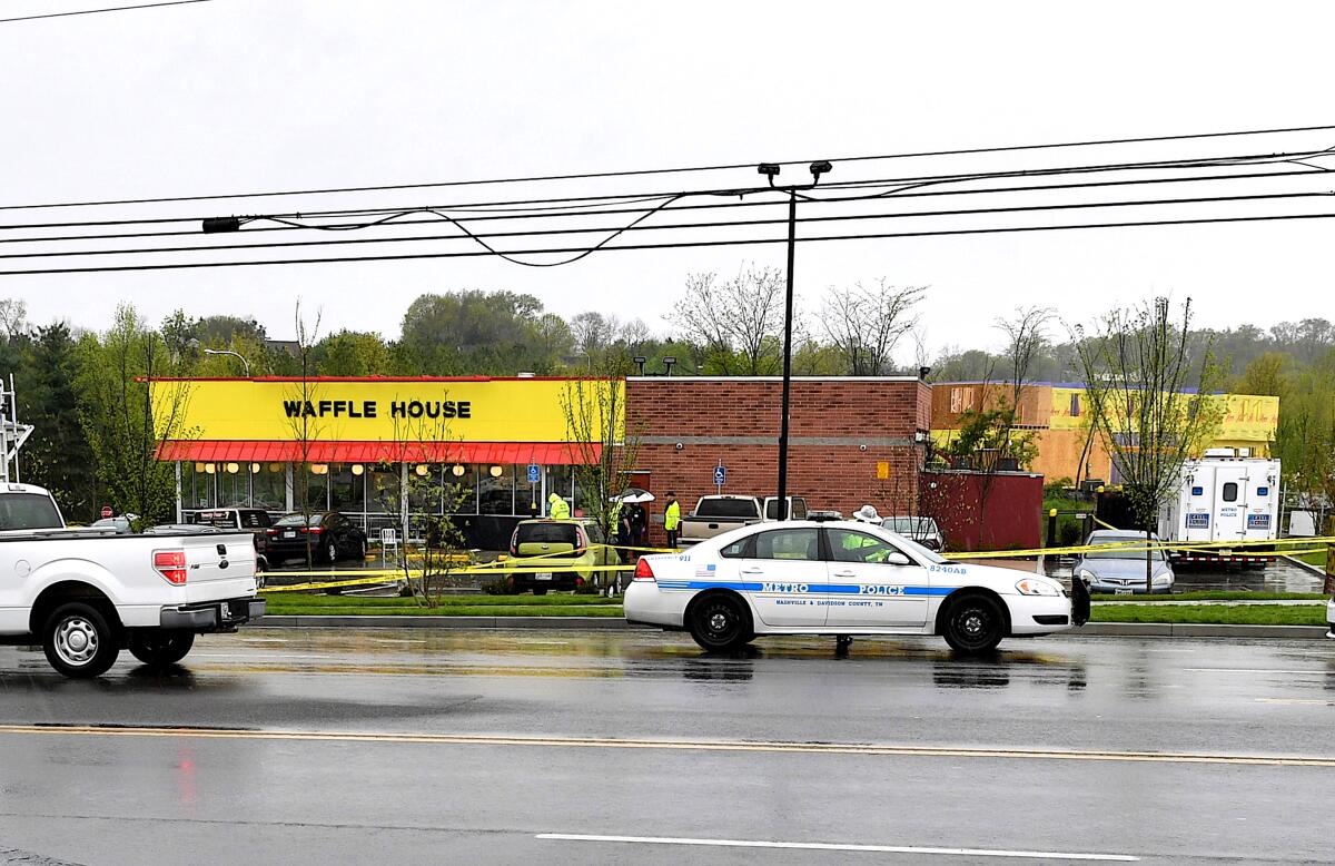 Police cars at the scene outside a Waffle House where four people were killed.