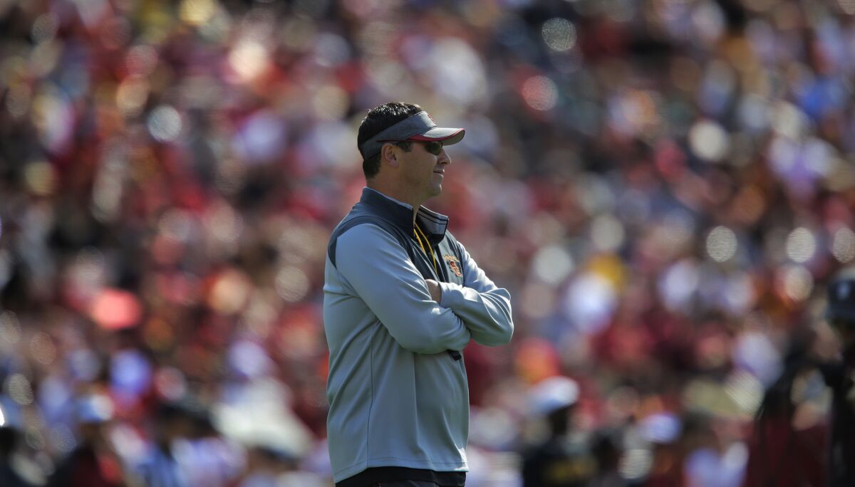 USC Coach Steve Sarkisian watches from behind the line of scrimmage during the annual spring game at the Coliseum on April 11.