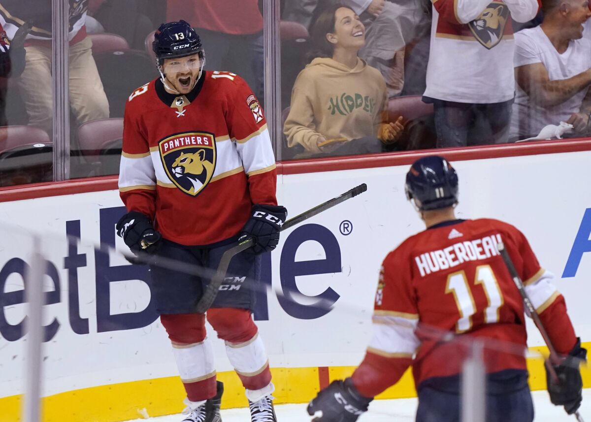 Florida Panthers center Sam Reinhart (13) celebrates his goal, assisted by left wing Jonathan Huberdeau (11), during the first period of the team's NHL hockey game against the Philadelphia Flyers, Thursday, March 10, 2022, in Sunrise, Fla. (AP Photo/Marta Lavandier)