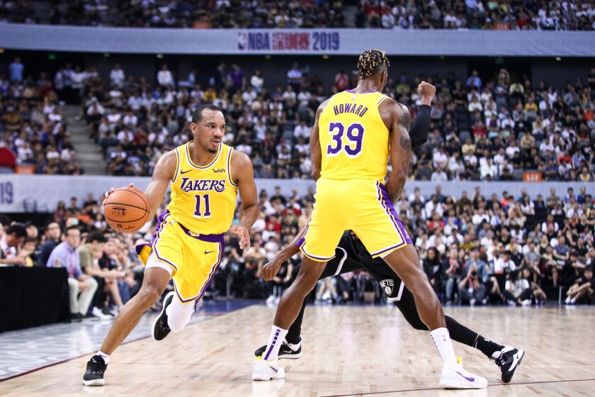 SHENZHEN, CHINA - OCTOBER 12: Avery Bradley #11 and Dwight Howard #39 of the Los Angeles Lakers in action during the match against the Brooklyn Nets during a preseason game as part of 2019 NBA Global Games China at Shenzhen Universiade Center on October 12, 2019 in Shenzhen, Guangdong, China. (Photo by Zhong Zhi/Getty Images)