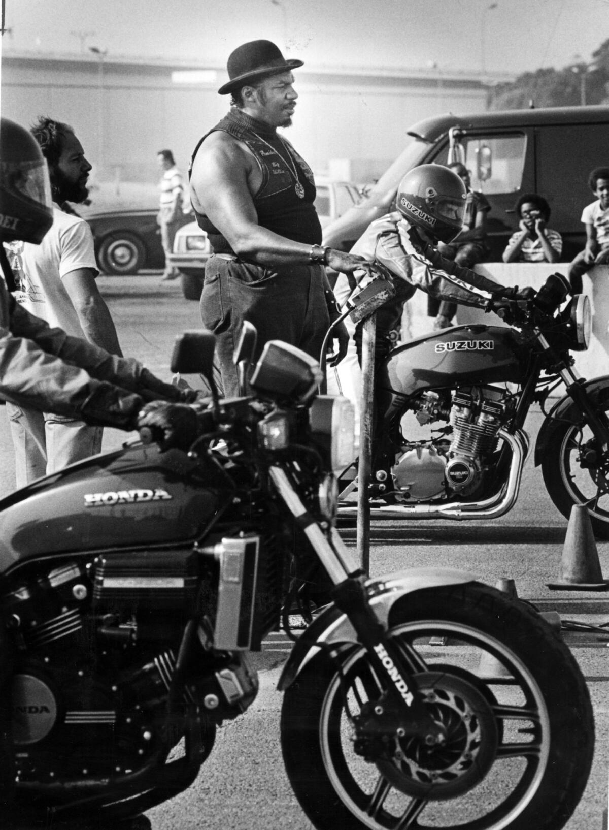 Big Willie supervises the start of a motorcycle race at the Terminal Island racetrack. (Rick Meyer / Los Angeles Times)