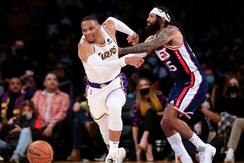 LOS ANGELES, CA - DECEMBER 25: Los Angeles Lakers guard Russell Westbrook (0) is fouled by Brooklyn Nets.