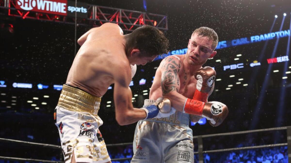 Leo Santa Cruz and Carl Frampton, right, exchange punches during their featherweight title bout in New York on July 30.