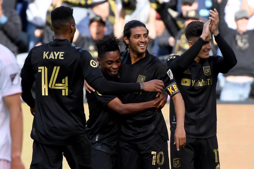 LOS ANGELES, CALIFORNIA - MARCH 01: Carlos Vela #10 of Los Angeles FC celebrates his goal with Latif Blessing #7, Mark-Anthony Kaye #14 and Jose Cifuentes #11 in front of Ben Sweat #22 of Inter Miami CF, to take a 1-1 lead, during the first half at Banc of California Stadium on March 01, 2020 in Los Angeles, California. (Photo by Harry How/Getty Images)