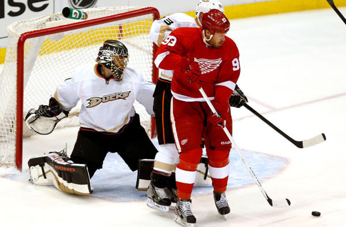 The Red Wings' right wing Johan Franzen tries to redirect a shot in front of Ducks defenseman Francois Beauchemin and goaltender Jonas Hiller in Game 6 of their playoff series.
