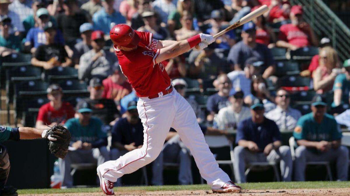 Angels first baseman-designated hitter C.J. Cron hits a home run against the Seattle Mariners during a spring training game on March 12.