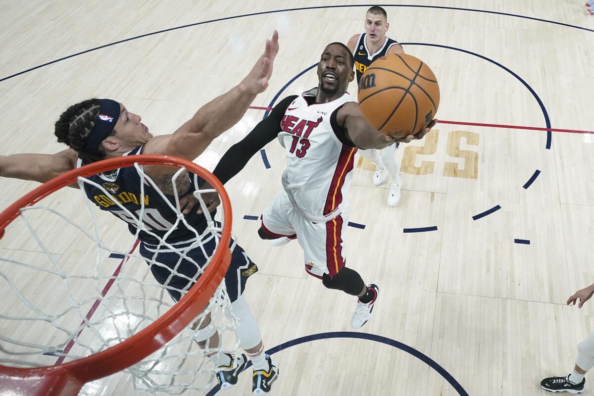 Miami center Bam Adebayo puts up a shot in front of Denver forward Aaron Gordon.