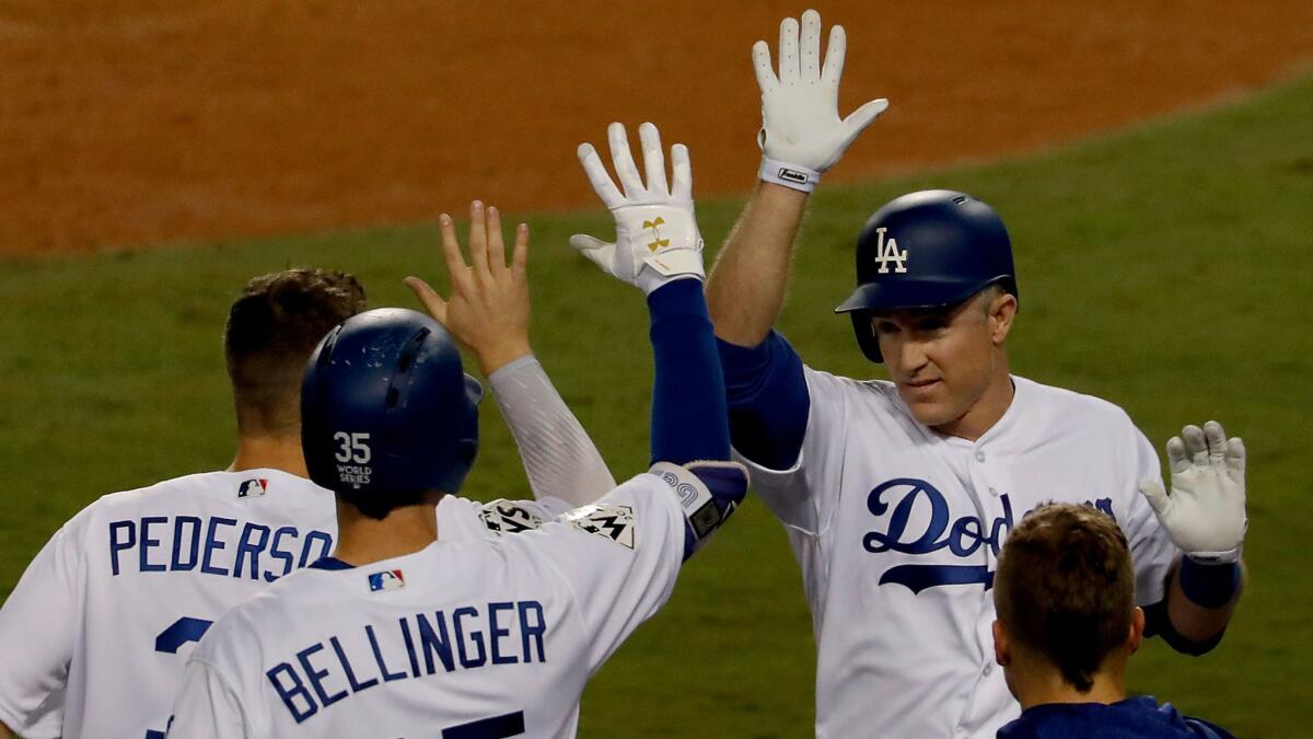 Dodgers second baseman Chase Utley, right, is congratulated by teammates Joc Pederson and Cody Bellinger after scoring a run against Houston in Game 6 of the World Series on Oct. 31.