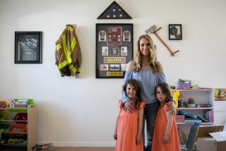 Temecula, CA - April 18: Caylie Valenta poses for a portrait with her daughters Lilly, 5, and Grace, 3, at their home on Monday, April 18, 2022 in Temecula, CA. Valenta has launched the Andy Valenta Melanoma Foundation in honor of her late husband and Vista firefighter, who died in 2021 after being diagnosed with a rare and aggressive form of brain cancer. (Adriana Heldiz / The San Diego Union-Tribune)