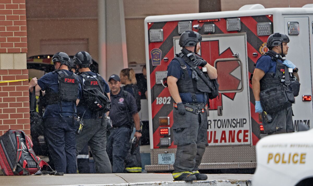 Law enforcement wait outside after a deadly shooting Sunday, July 17, 2022, at the Greenwood Park Mall, in Greenwood, Ind. (Kelly Wilkinson/The Indianapolis Star via AP)