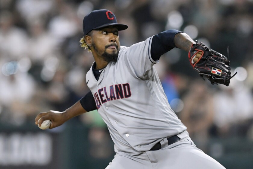 FILE -Cleveland Indians closing pitcher Emmanuel Clase winds up during the ninth inning of the team's baseball game against the Chicago White Sox on Saturday, July 31, 2021, in Chicago. Unable to add to their roster via free agency, the Cleveland Guardians locked up one of their own, agreeing to terms with closer Emmanuel Clase on a five-year, $20 million contract extension, a person familiar with the negotiations told The Associated Press on Saturday, April 2, 2022. (AP Photo/Paul Beaty, File)