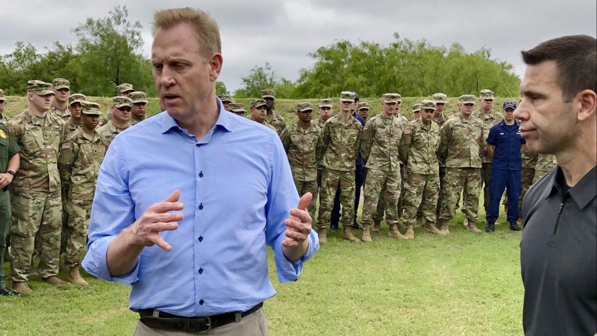 Acting Defense secretary Patrick Shanahan, left, speaks with troops near McAllen, Texas, on Saturday. At right is Kevin McAleenan, acting Homeland Security secretary.