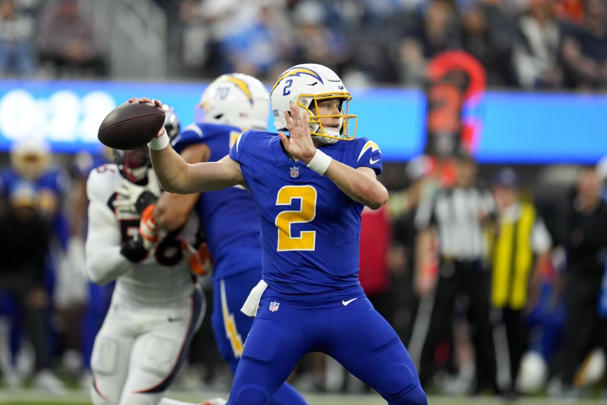 Chargers quarterback Easton Stick (2) looks to throw a pass against the Denver Broncos .