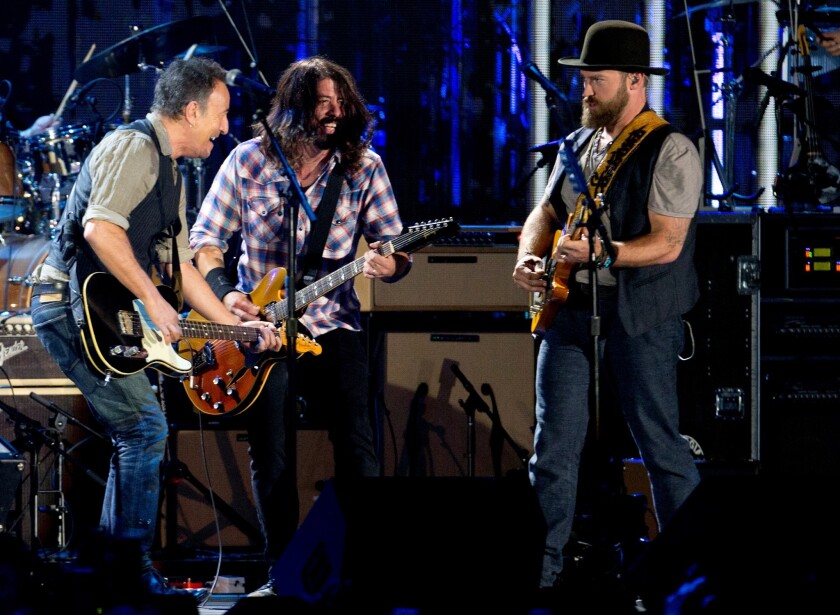 Bruce Springsteen, left, shown with Dave Grohl, center, and Zac Brown, has drawn criticism for performing John Fogerty's "Fortunate Son" during Tuesday's Concert For Valor in Washington, D.C.