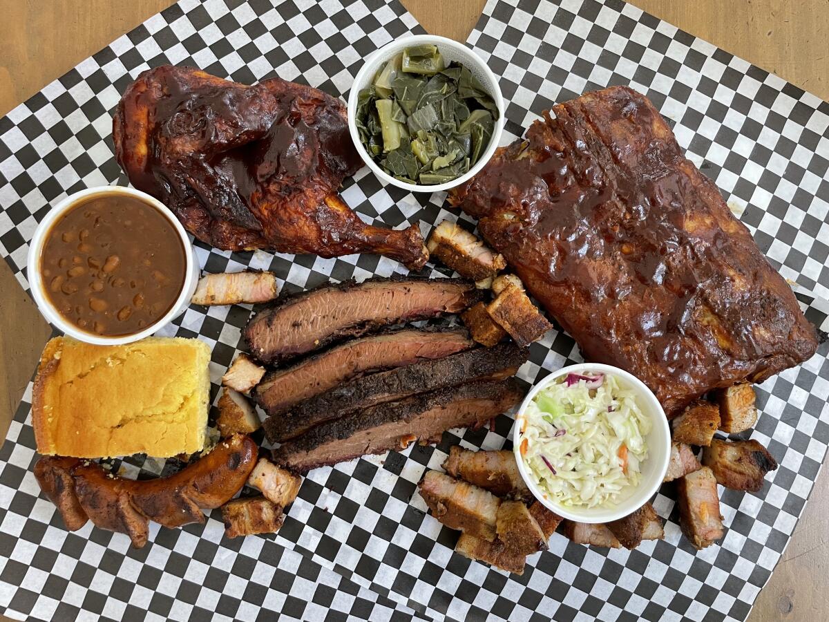 A spread of ribs, coleslaw, cornbread and baked beans