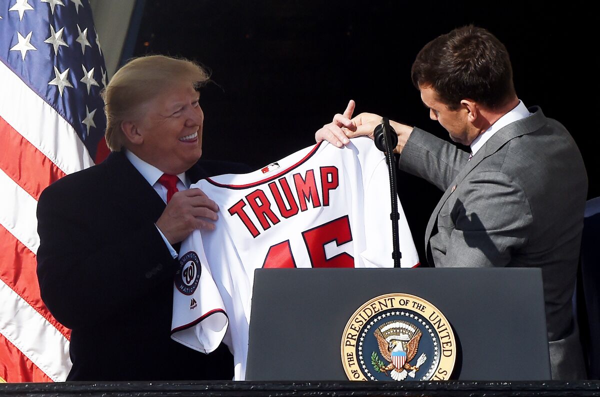 President Trump receives a jersey from Nationals first baseman Ryan Zimmerman