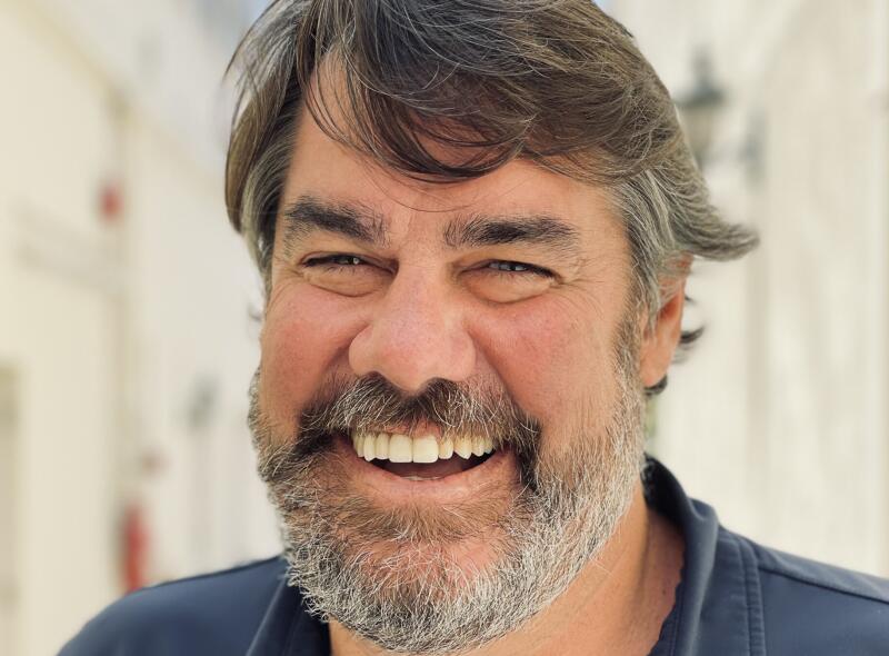 Headshot of Jack Martin smiling in a blue polo shirt.